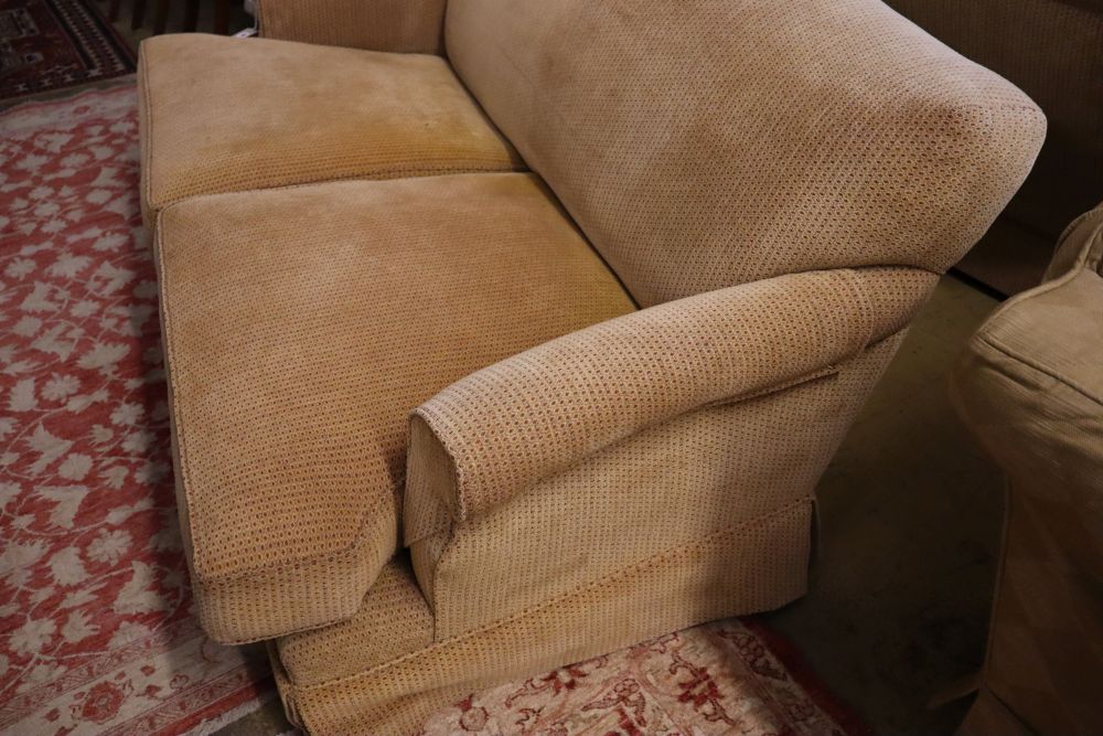 A pair of contemporary beige upholstered two seater settees, width 180cm depth 106cm max height 80cm